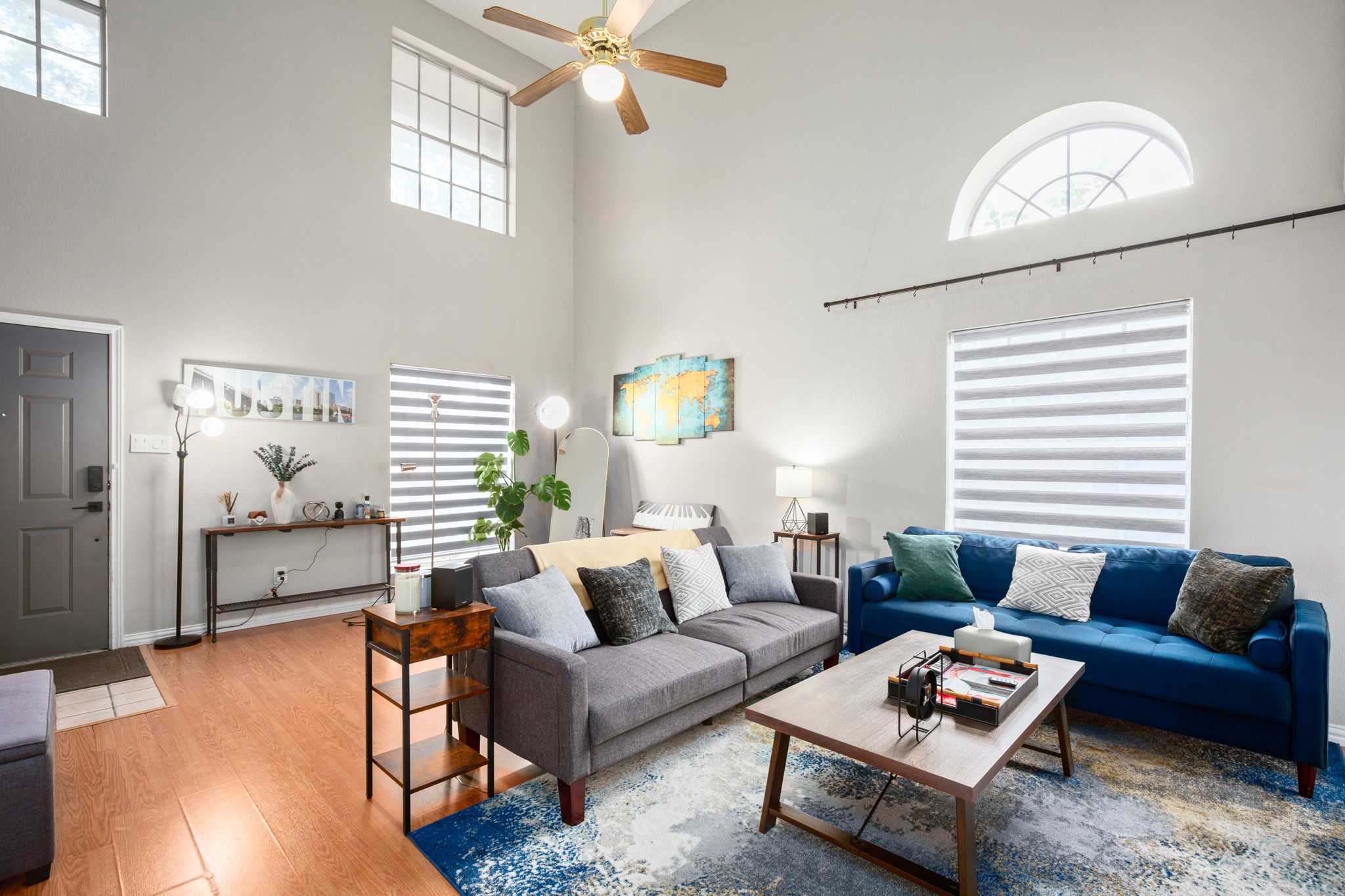 13803 Randalstone Drive Pflugerville, TX 78660 - Photo 8 of 27 Living area featuring ceiling fan, wood finished floors, and a high ceiling