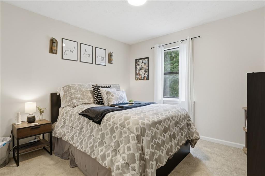 404 Brooks Street Dallas, GA 30157 - Photo 23 of 38 a bed sitting in a bedroom next to a window