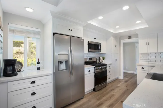 a kitchen with a sink stove top oven and refrigerator