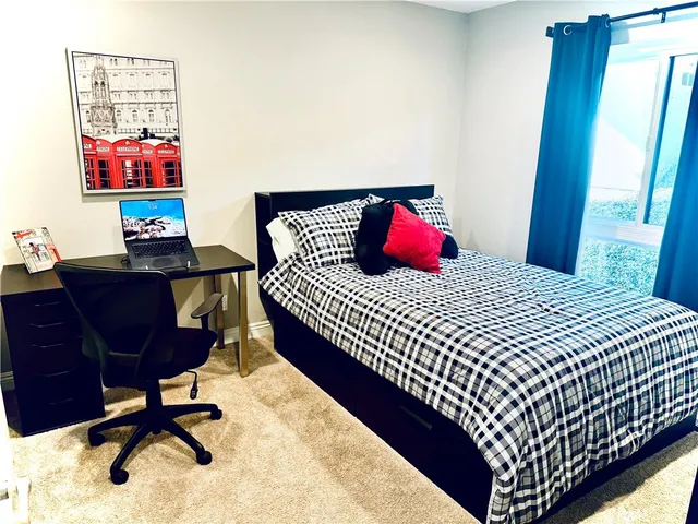 a bedroom with a bed and a chair