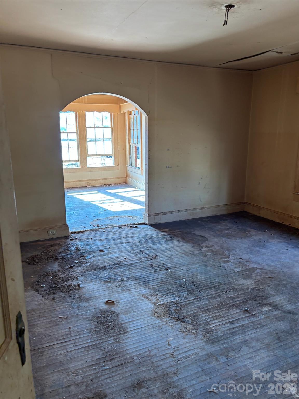 5724 Mooresville Road Kannapolis, NC 28081 - Photo 11 of 15 an empty room with wooden floor and windows