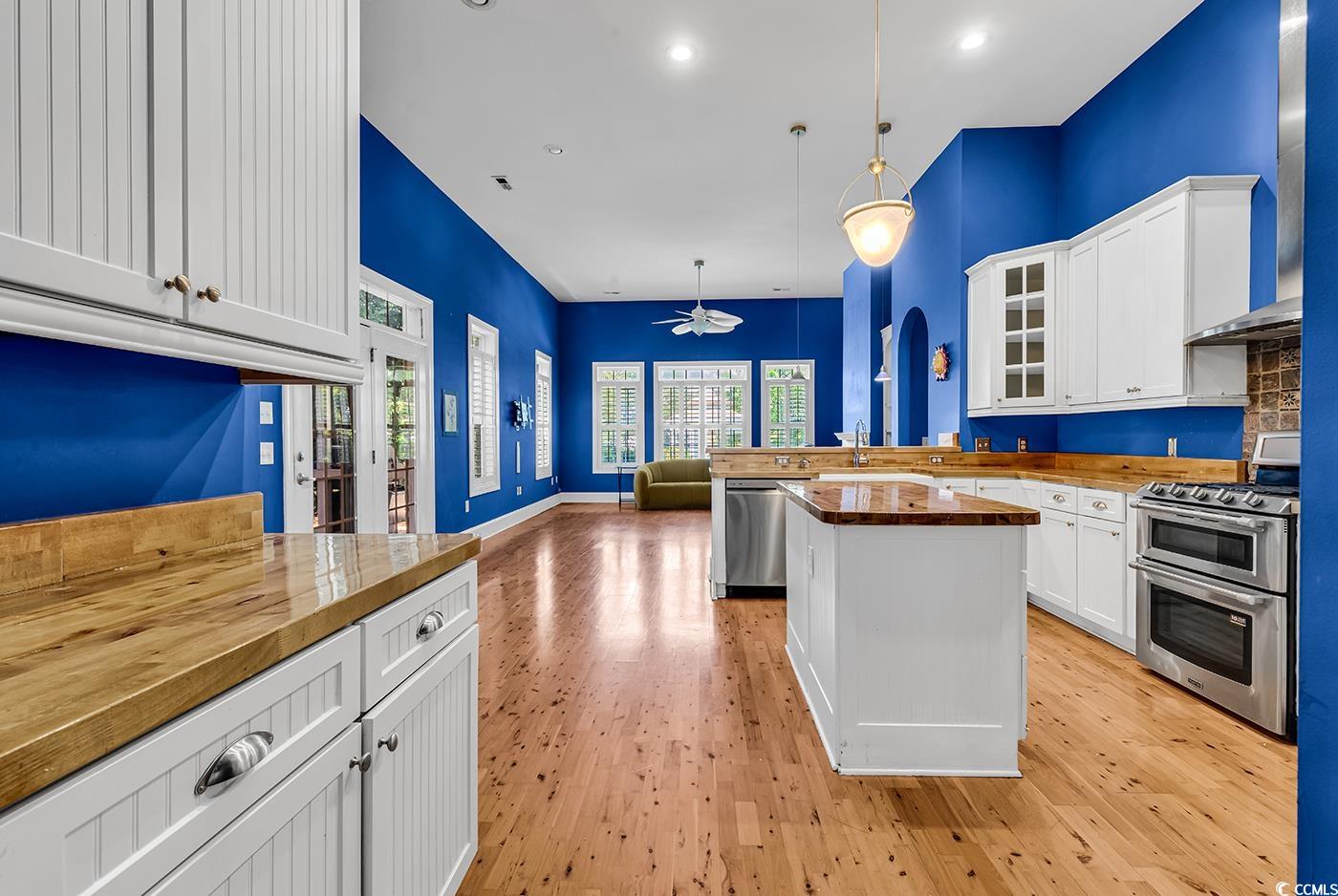 553 Linton Park Road Myrtle Beach, SC 29579 - Photo 9 of 40 Kitchen featuring glass insert cabinets, ceiling fan, white cabinetry, a peninsula, and recessed lighting