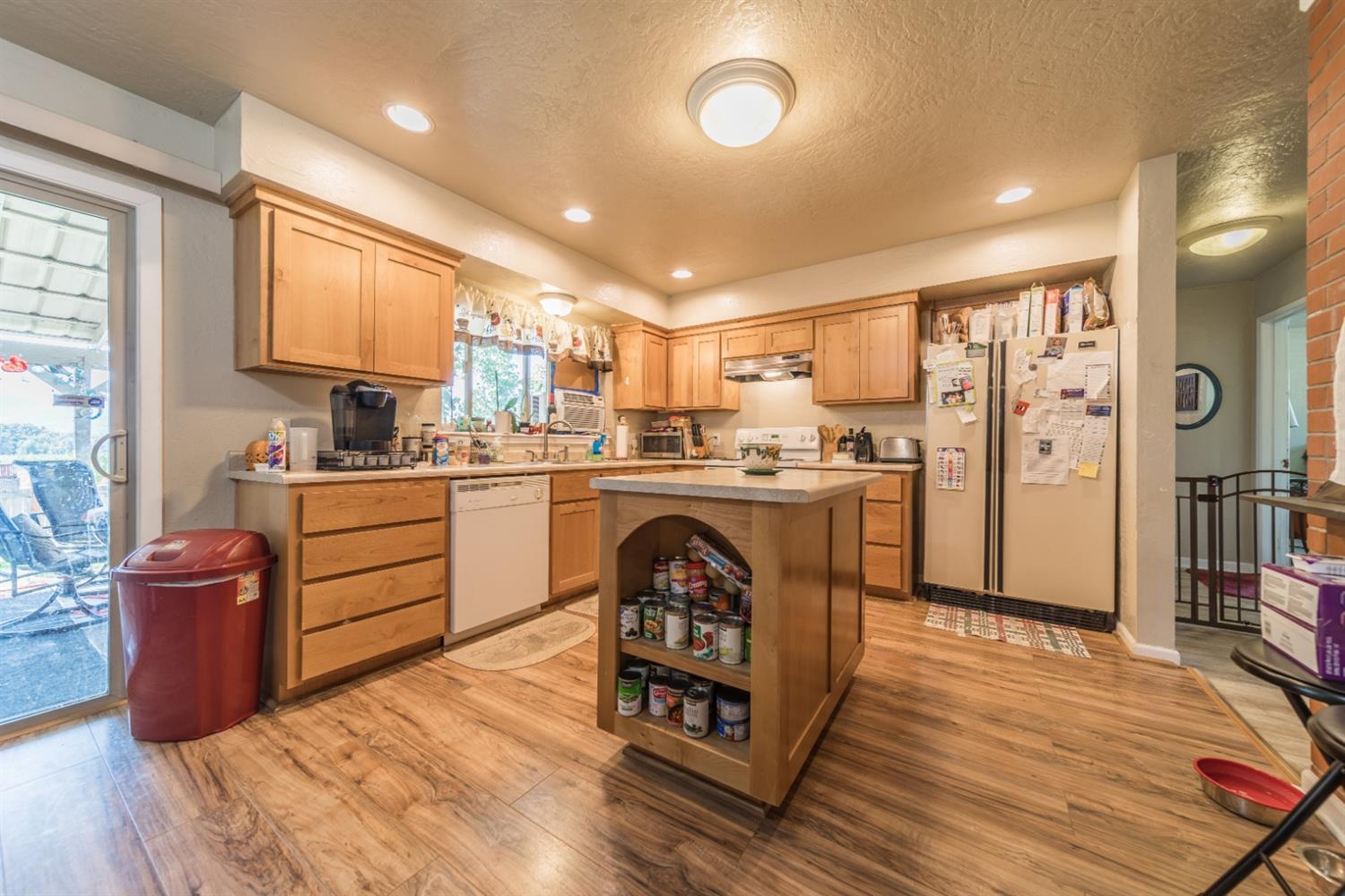 728 West Valley View Road Ashland, OR 97520 - Photo 24 of 32 a kitchen with stainless steel appliances granite countertop a sink a stove a refrigerator cabinets and wooden floor