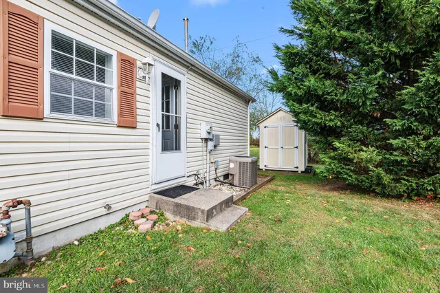 a backyard of a house with garden and barbeque oven