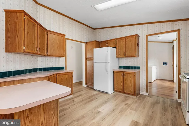 a kitchen with refrigerator and cabinets