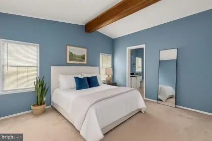 a bedroom with a bed and a large mirror