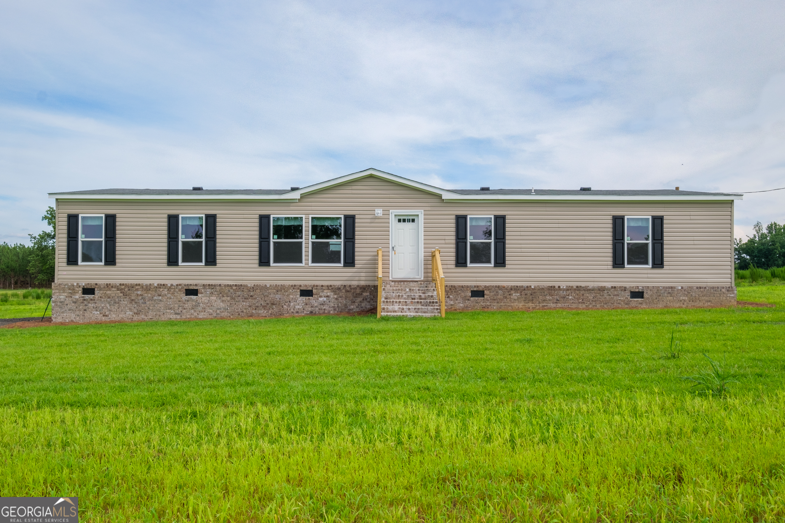 a front view of house with yard and outdoor seating