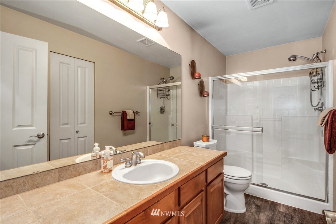 27752 Maple Ridge Way Southeast Maple Valley, WA 98038 - Photo 11 of 25 a bathroom with a granite countertop sink toilet and shower