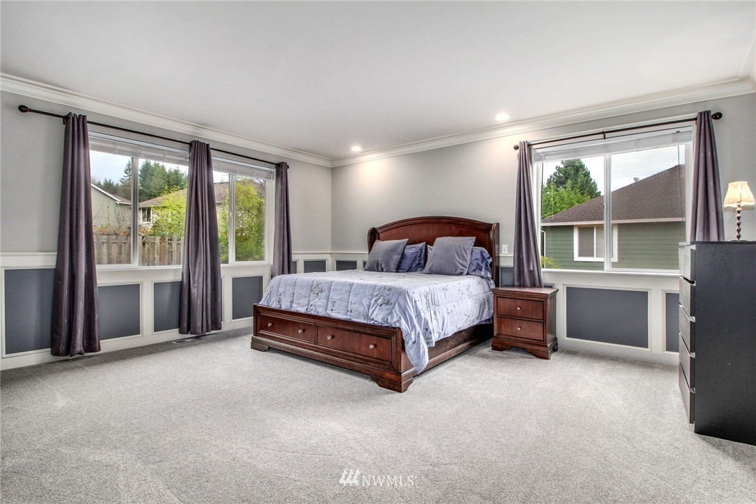27752 Maple Ridge Way Southeast Maple Valley, WA 98038 - Photo 14 of 25 a bedroom with a bed and a large window