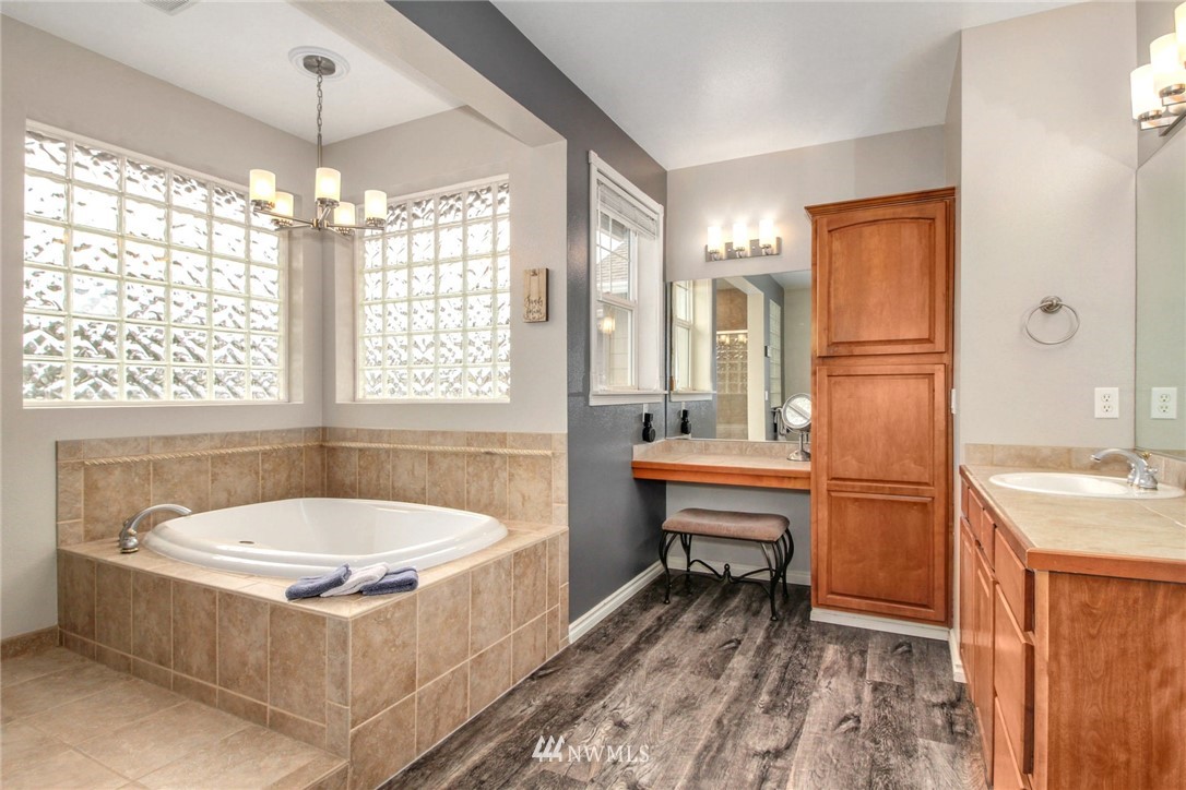 27752 Maple Ridge Way Southeast Maple Valley, WA 98038 - Photo 16 of 25 a bathroom with a tub sink and mirror