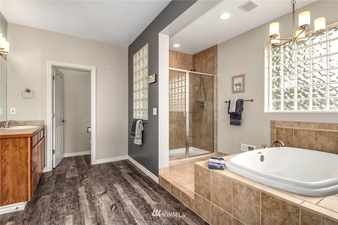 27752 Maple Ridge Way Southeast Maple Valley, WA 98038 - Photo 17 of 25 a spacious bathroom with a tub sink and shower