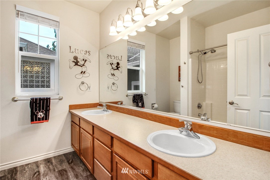 27752 Maple Ridge Way Southeast Maple Valley, WA 98038 - Photo 18 of 25 a bathroom with a sink double vanity granite tub shower and a mirror
