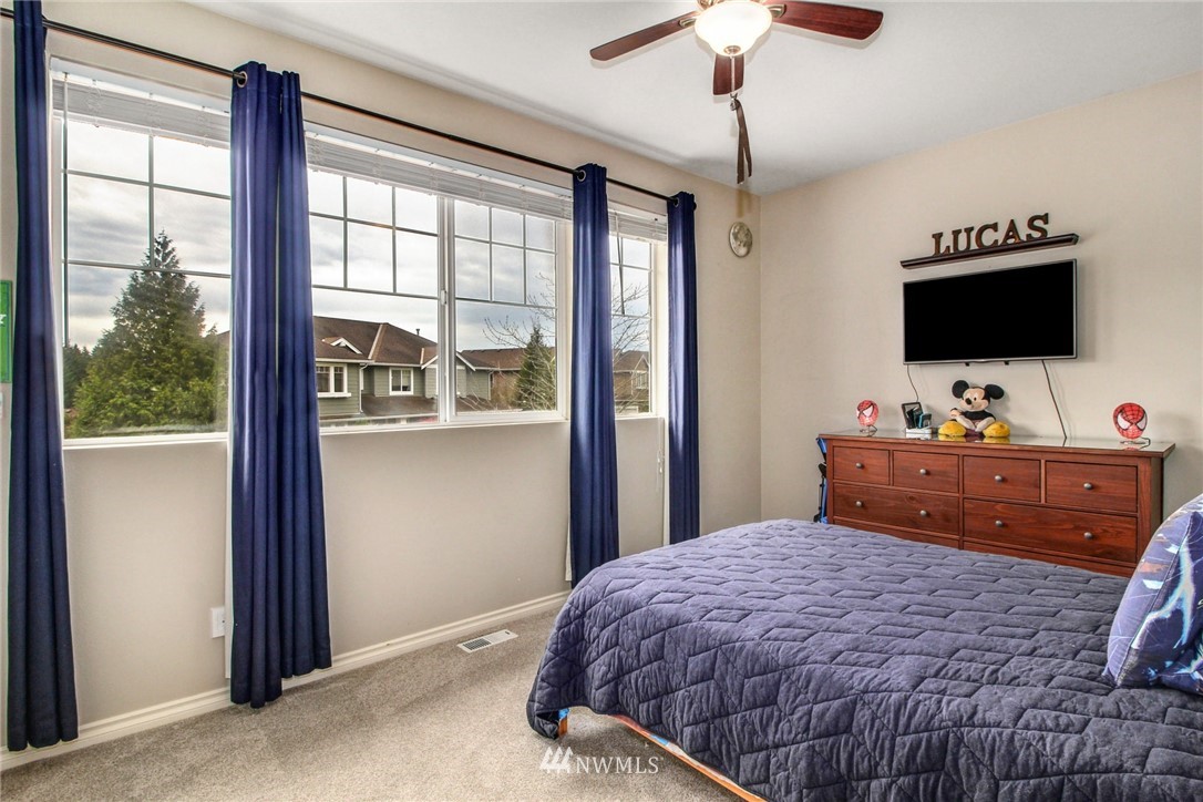 27752 Maple Ridge Way Southeast Maple Valley, WA 98038 - Photo 19 of 25 a bedroom with a bed and a flat screen tv