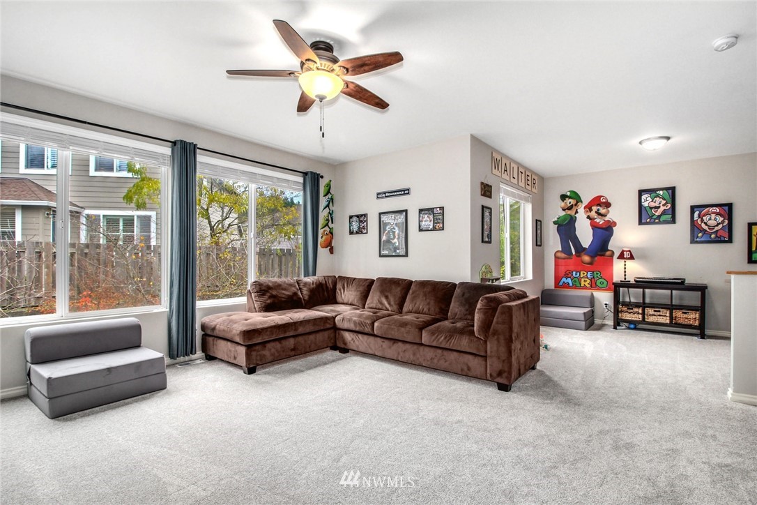27752 Maple Ridge Way Southeast Maple Valley, WA 98038 - Photo 21 of 25 a living room with furniture and a large window