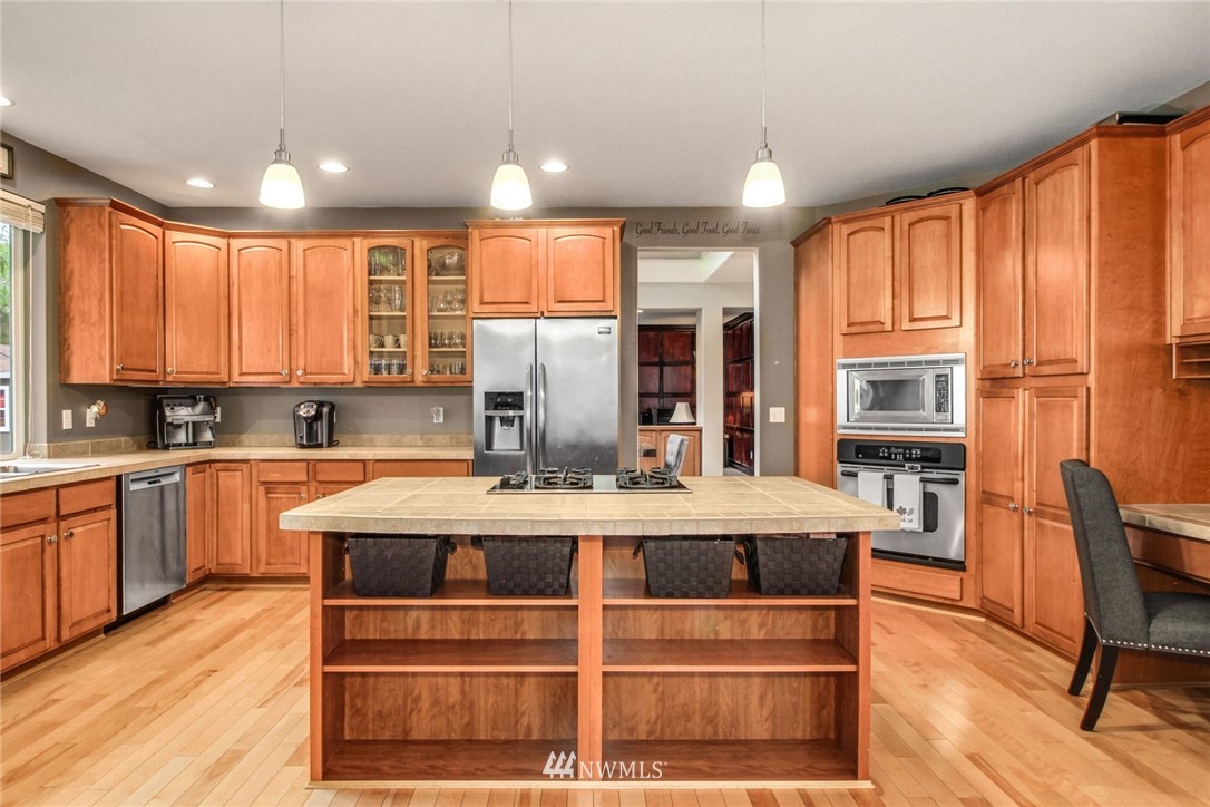 27752 Maple Ridge Way Southeast Maple Valley, WA 98038 - Photo 7 of 25 a large kitchen with kitchen island a large window