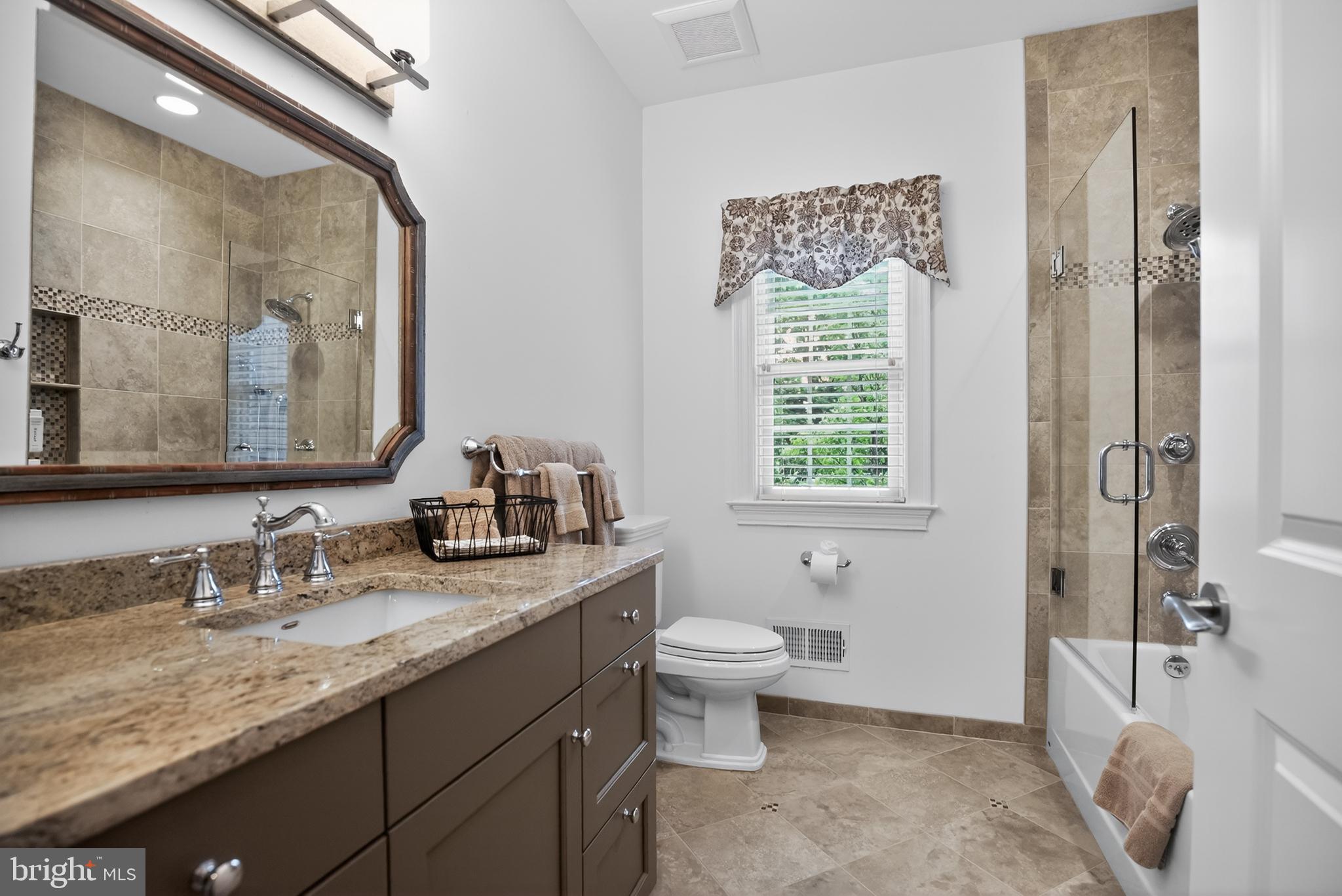 1031 Coates Road Jenkintown, PA 19046 - Photo 41 of 66 a bathroom with a granite countertop sink toilet and shower