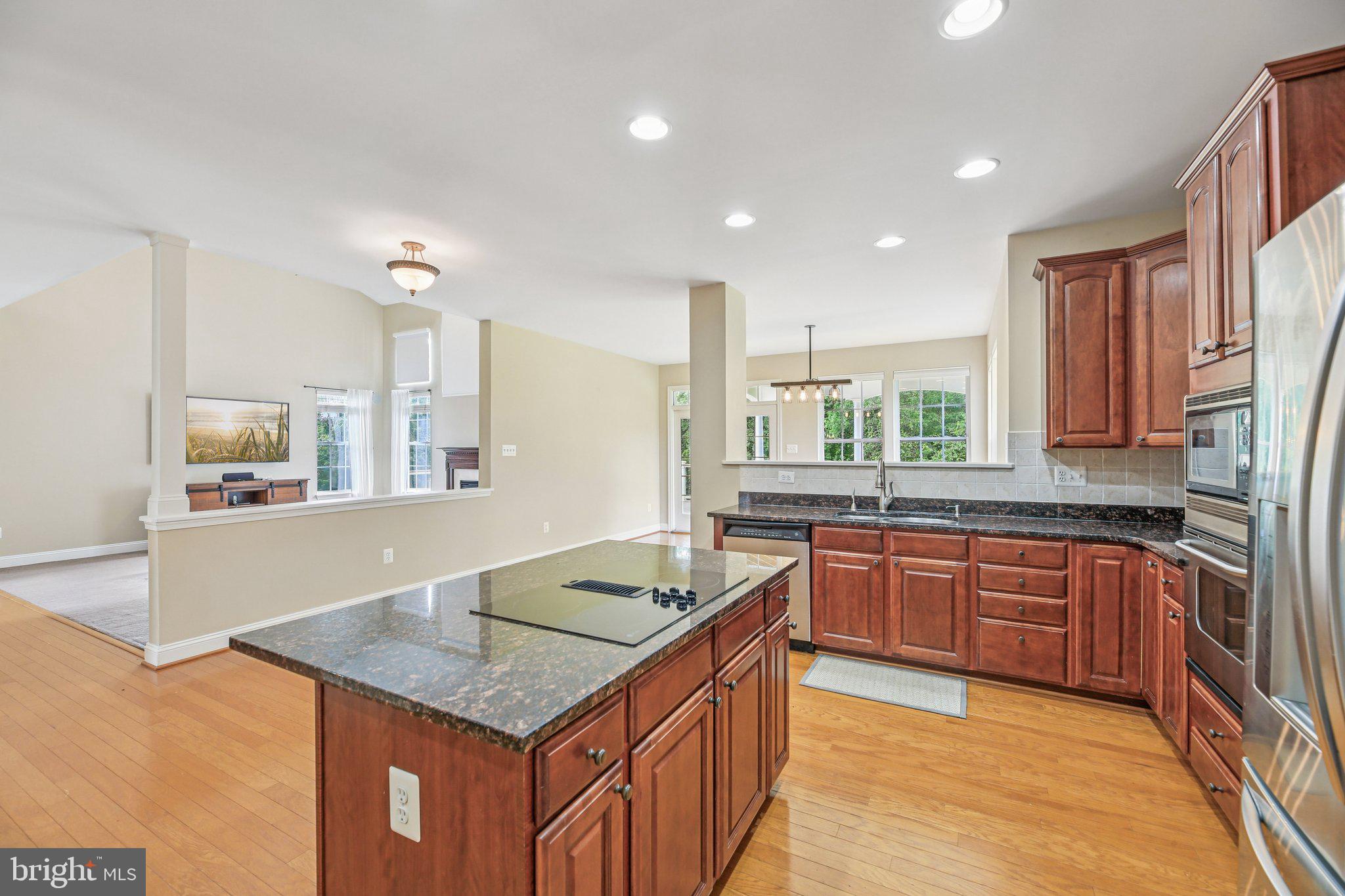 705 Jaclyn Circle Freeland, MD 21053 - Photo 13 of 45 a kitchen with stainless steel appliances granite countertop a sink stove and cabinets