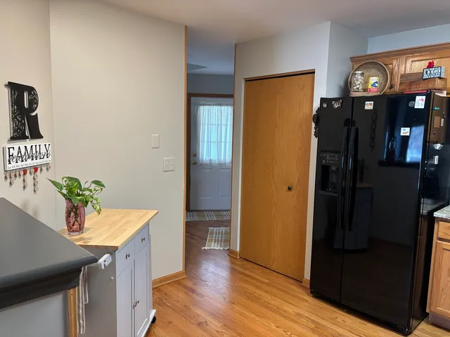 a kitchen with stainless steel appliances a refrigerator and a table