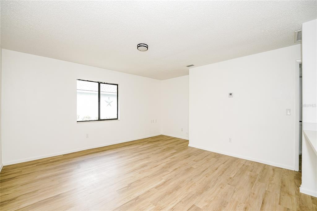 26 Seneca Path Palm Coast, FL 32164 - Photo 3 of 15 an empty room with wooden floor and windows