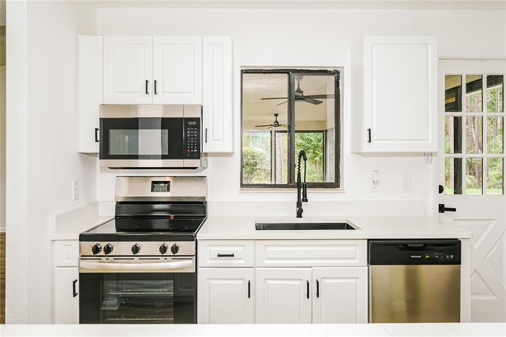 26 Seneca Path Palm Coast, FL 32164 - Photo 7 of 15 a kitchen with cabinets appliances a sink and a window