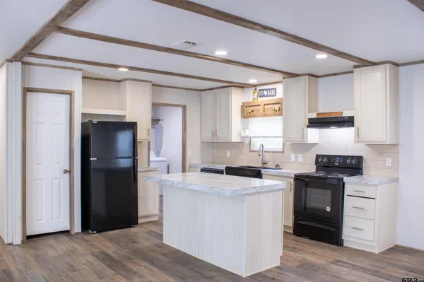 a kitchen with a stove a sink and a refrigerator