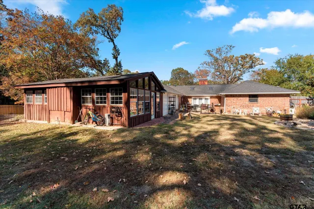 a view of a house with backyard and sitting area