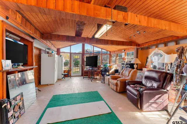 a big house with wooden wall in front of it