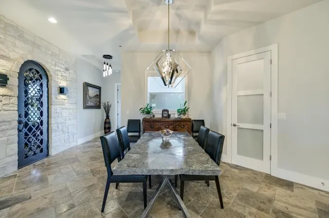 a view of a dining room with furniture and a chandelier