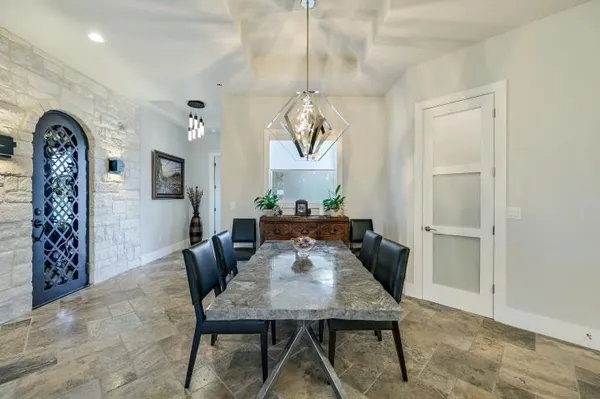 a view of a dining room with furniture and a chandelier