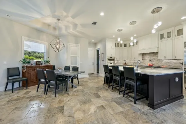 a large kitchen with a table and chairs