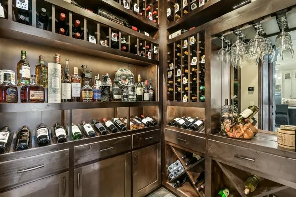 a kitchen area with lots of bottles of alcohol