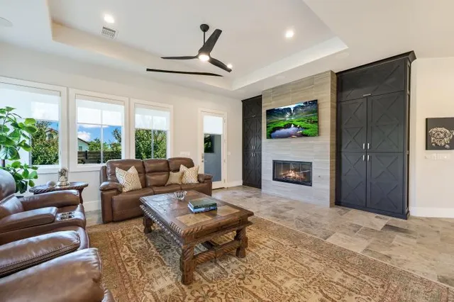 a living room with furniture a window and a fireplace
