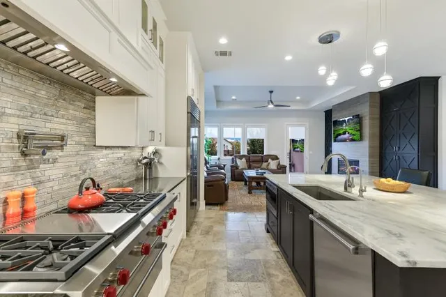 a kitchen with sink stove and cabinets