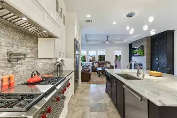 a kitchen with sink stove and cabinets