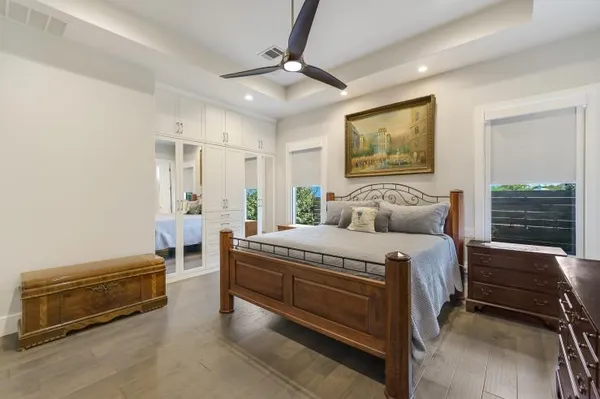 a bedroom with a bed and a chandelier