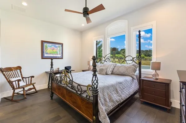 a spacious bedroom with a bed and a couch