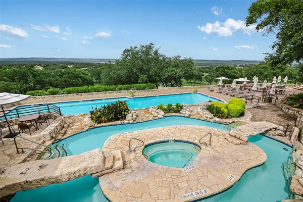 a swimming pool with outdoor seating and garden