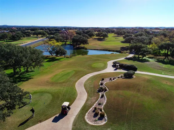 a view of a golf course with a ocean view