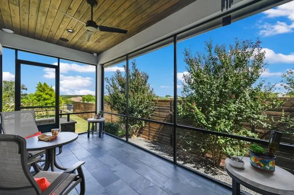 a balcony with furniture and a potted plant