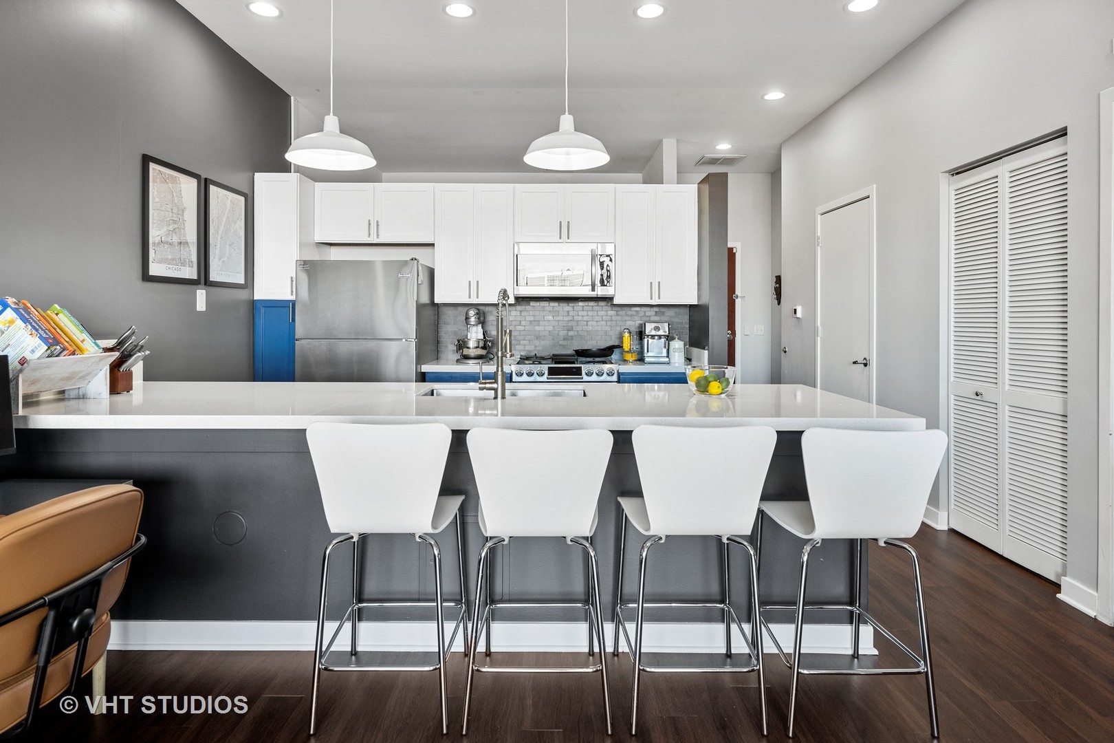 3920 North Sheridan Road, Unit 403 Chicago, IL 60613 - Photo 2 of 13 a dining room with stainless steel appliances kitchen island granite countertop a dining table chairs and a refrigerator