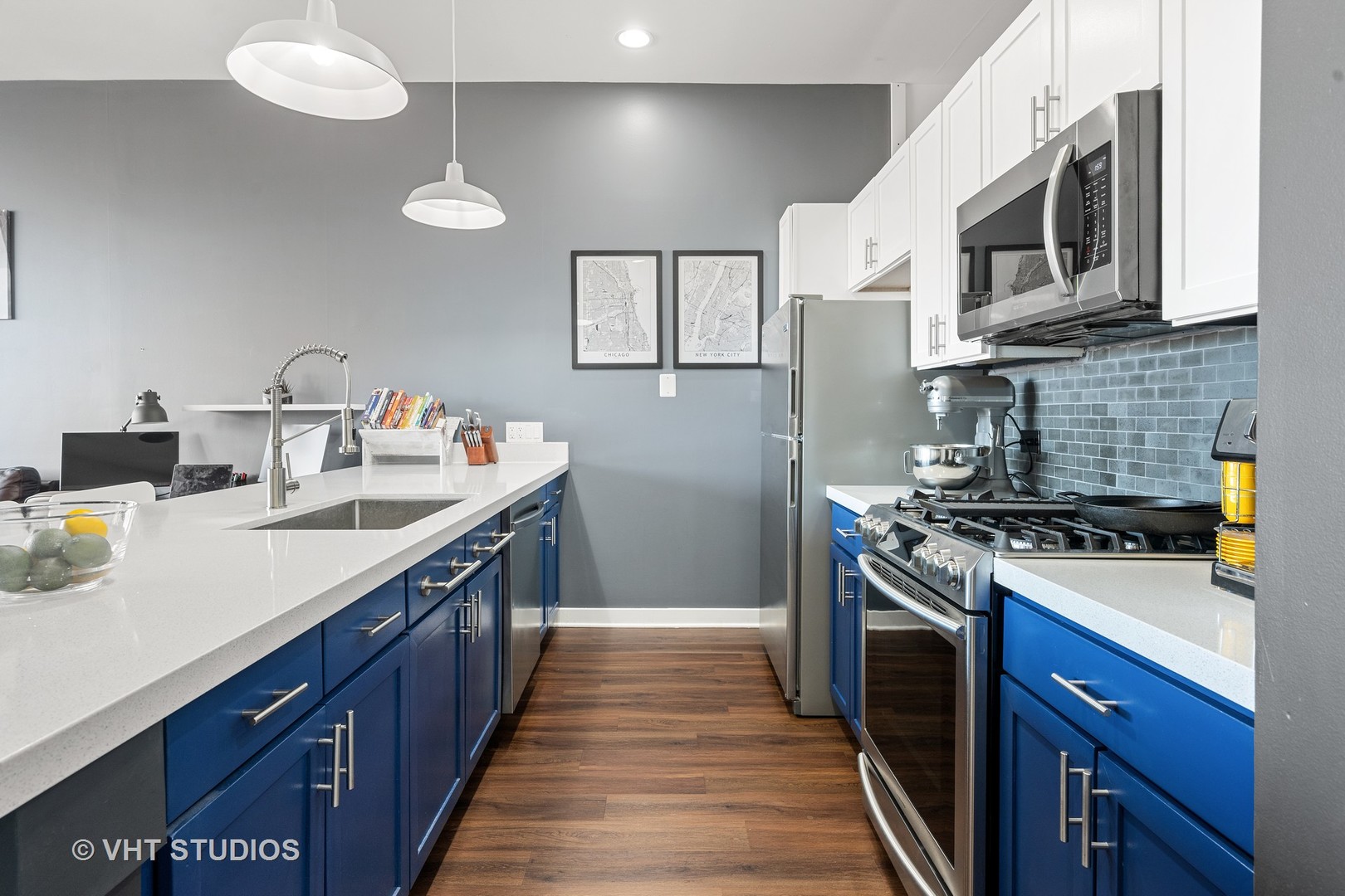 3920 North Sheridan Road, Unit 403 Chicago, IL 60613 - Photo 3 of 13 a kitchen with stainless steel appliances granite countertop a stove a sink dishwasher and a microwave oven with white cabinets