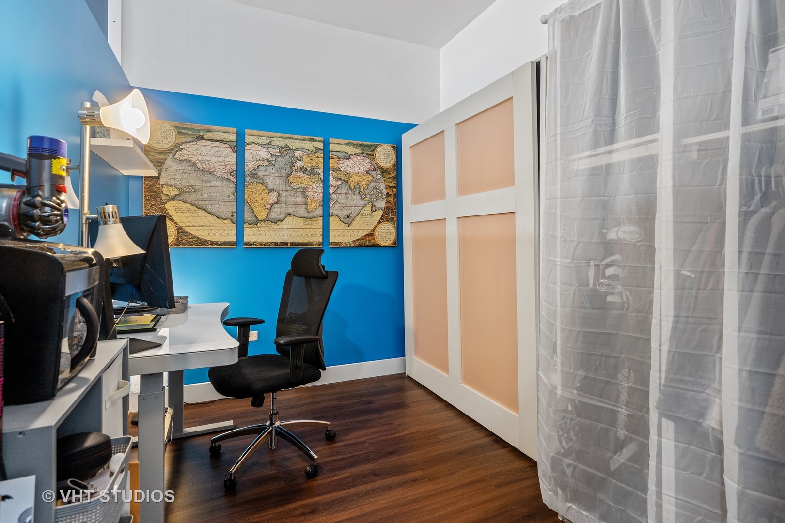 3920 North Sheridan Road, Unit 403 Chicago, IL 60613 - Photo 9 of 13 a workspace with wooden floor and windows