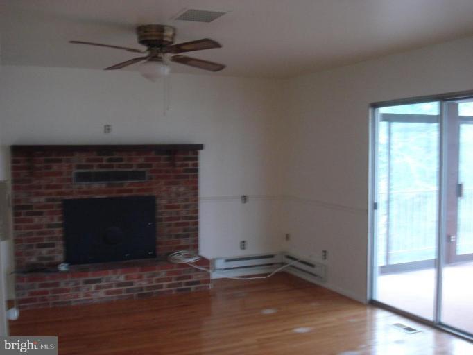816 Riverside Drive Pasadena, MD 21122 - Photo 5 of 16 Family room with wood fireplace