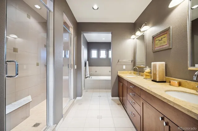 a spacious bathroom with a granite countertop sink and a mirror