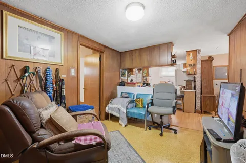 a living room with furniture a flat screen tv and a couch