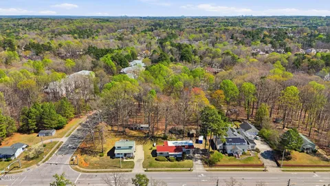 an aerial view of residential houses with trees