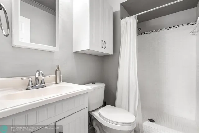 a bed room with a bed and a white wall