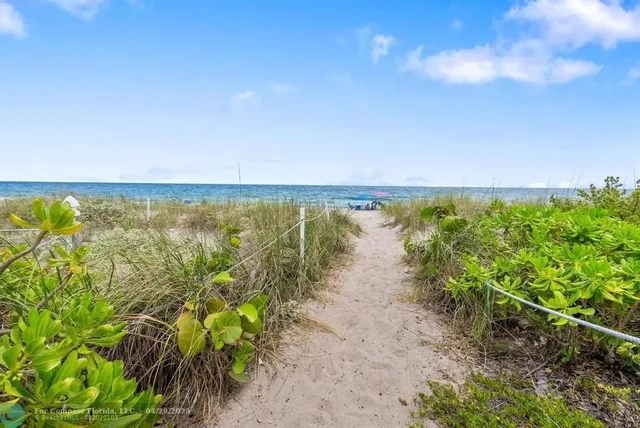 a kitchen with granite countertop a sink stainless steel appliances and white cabinets