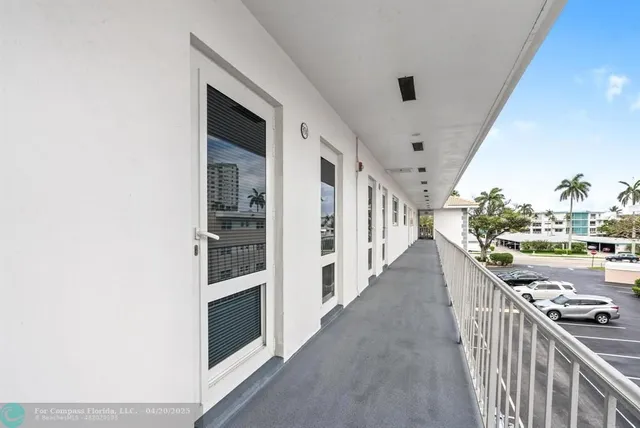 a view of a patio with plants and chairs