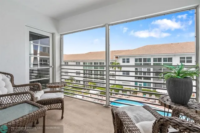 a living room with furniture flat screen tv and windows